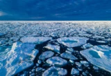 The Collision Physics Behind Arctic Sea Ice: A New Paradigm in Climate Modeling